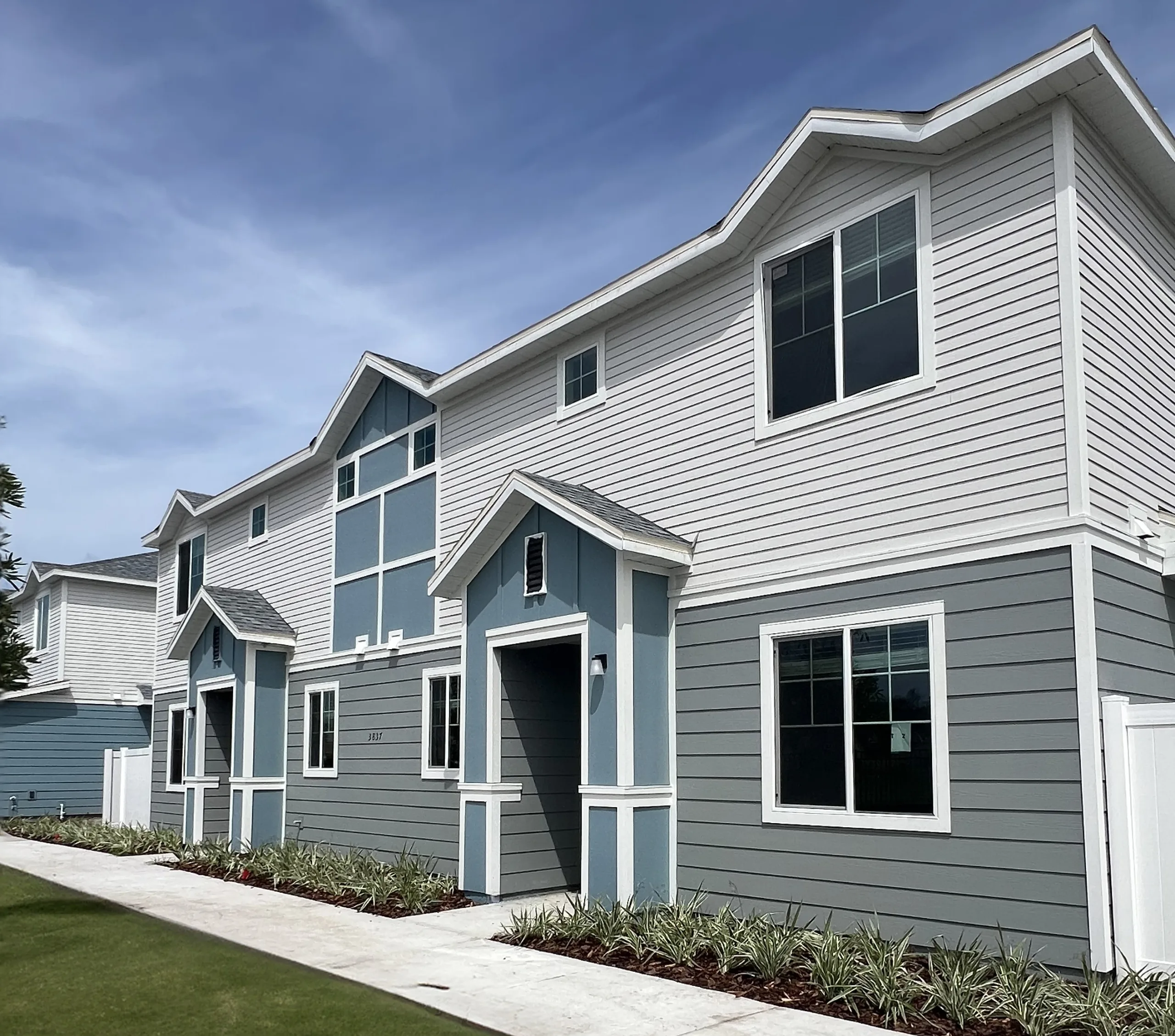 rendering of front of quad townhomes- each unit is a corner unit! New pet-friendly apartment homes for rent with private fenced backyards in Kissimmee, FL, near Orlando, FL with pickle ball, dog park, gym, and gated community.